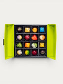 Norman Love Confections 16-piece assorted chocolate gift box with vibrant, uniquely decorated chocolates in a lime green box.