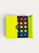 Norman Love Confections 5-Layer Birthday Cake Gift Box with assorted colorful chocolates.