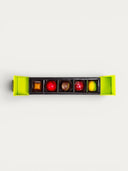 Norman Love Confections 5 piece assorted chocolate box with red, yellow, and brown chocolates.