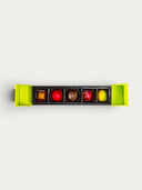 Norman Love Confections 5 piece gift box of assorted chocolates including caramel, red, chocolate, red with sprinkles, and yellow-green.