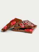 Norman Love Confections Dark Chocolate Raspberry Crunch Bar with freeze-dried raspberries and chocolate pearls.