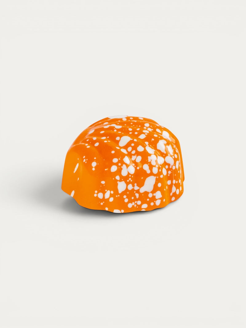 Norman Love Confections Florida Orange chocolate with white speckles.