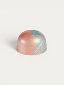 Norman Love Confections German Chocolate Cake truffle with copper and blue splatter detail.