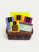 Norman Love Confections Gourmet Extravaganza gift basket with assorted chocolate bars and a signature gift box.