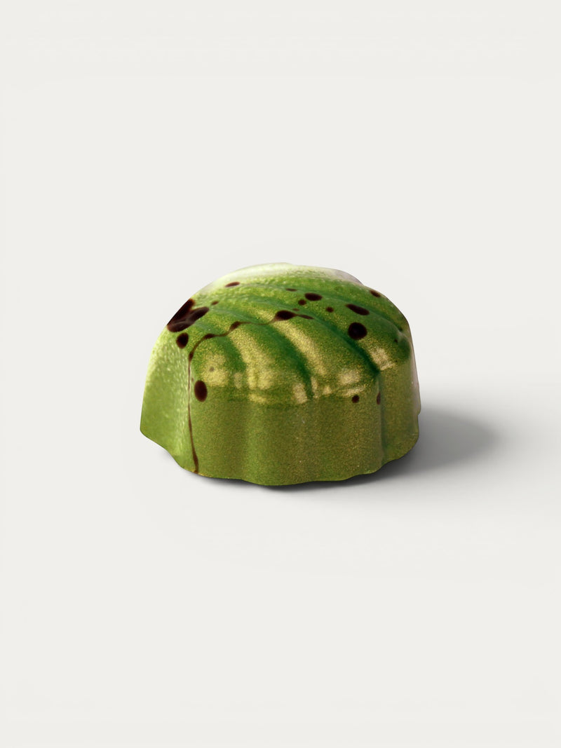 Norman Love Confections green chocolate peanut butter cup with crunchy texture and dark chocolate drizzle.