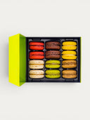 Norman Love Confections 12 piece macaron gift box with 6 flavors: red raspberry, chocolate, yellow lemon, cream vanilla, green pistachio, and brown caramel.