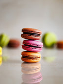 Norman Love Confections 12 piece macaron gift box featuring French macarons in chocolate, raspberry, and caramel flavors.