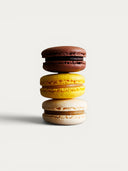 Norman Love Confections 6 Piece Macaron Gift Box: Chocolate, yellow, and vanilla macarons stacked.