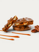 Norman Love Confections Milk Chocolate Caramel Pecan Turtles with creamy caramel and candied pecans.