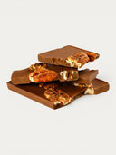 Norman Love Confections Pecan Turtle Bar: milk chocolate bar with whole pecans embedded.