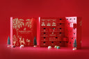 Norman Love Confections red advent calendar with 24 drawers, gold holiday illustrations, and miniature pine trees.