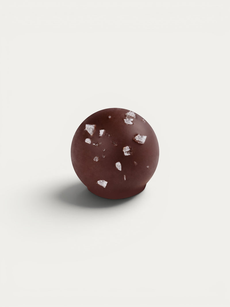 Norman Love Confections Sea Salt Caramel Truffle, dark chocolate with caramel filling and sea salt flakes.