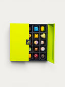 Norman Love Confections 50 piece signature chocolate collection in a two-tiered green gift box. Assorted milk, dark, and white chocolates.