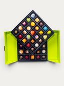 Norman Love Confections 50 piece signature chocolate gift box in a two-tiered green box, featuring assorted milk, dark, and white chocolates.