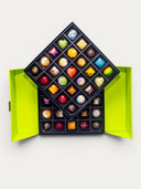 Norman Love Confections 50 piece signature chocolate gift box in a two-tiered green box, featuring assorted milk, dark, and white chocolates.
