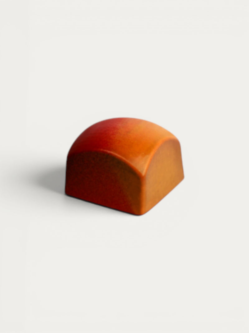 Norman Love Confections Strawberry Shortcake ganache truffle, rich dark chocolate with strawberry filling, smooth glossy finish.