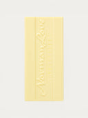 Norman Love Confections white chocolate bar with embossed logo and segmented design.