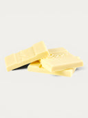 Norman Love Confections white chocolate bar pieces with embossed lettering.