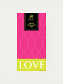 Norman Love Confections White Chocolate Bar with pink and lime green packaging and the word LOVE.