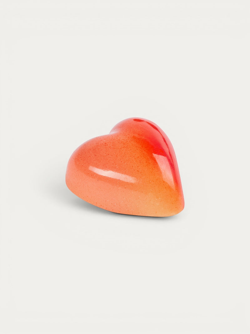 Norman Love Confections White Chocolate Raspberry heart-shaped chocolate with a glossy red and orange gradient finish.